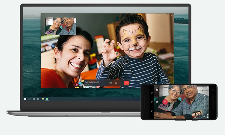 Grandparents video chatting with family using WhatsApp on a laptop and smartphone
