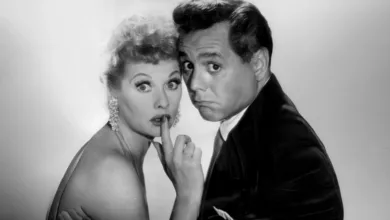 Lucille Ball with finger to her lips and Desi Arnaz looking exasperated in a playful 1957 I Love Lucy promotional portrait