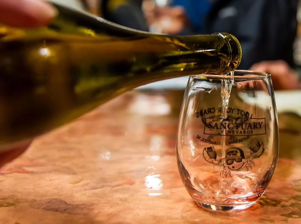 "White wine poured into a glass — Sanctuary Vineyards in Jarvisburg, North Carolina