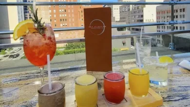 DARTable Sips: The Best Bars and Rooftops You Can Reach on DART This Summer 1 Rooftop patio at Sky Blossom Vietnamese fusion bistro with summer cocktails and panoramic view of downtown Dallas skyline