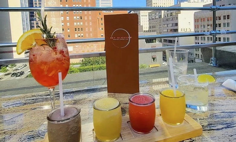 Rooftop patio at Sky Blossom Vietnamese fusion bistro with summer cocktails and panoramic view of downtown Dallas skyline