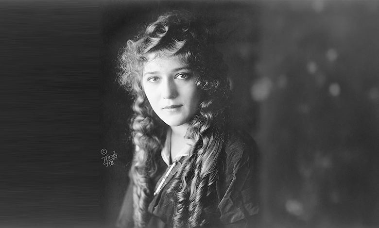 Black and white portrait of Mary Pickford with long curly hair looking directly at the camera, photographed by Moody, N.Y.