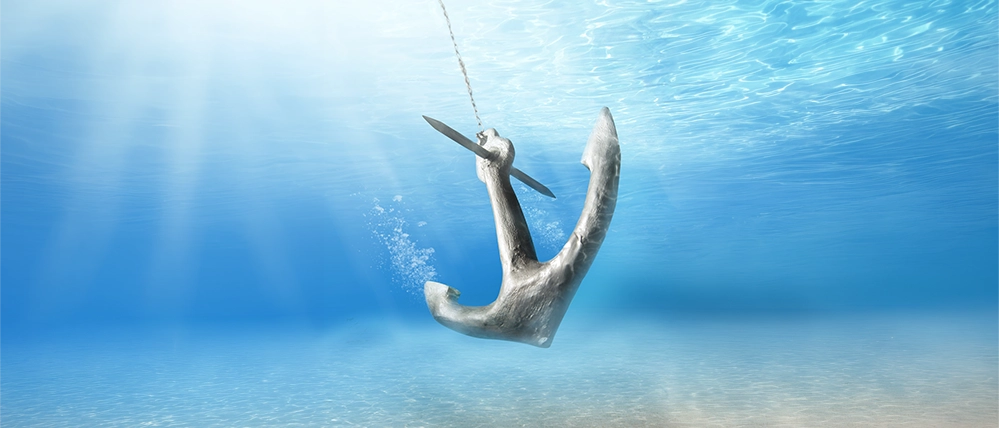What’s Your Anchor in Retirement? 2 An anchor descending through clear blue water on a taut chain.