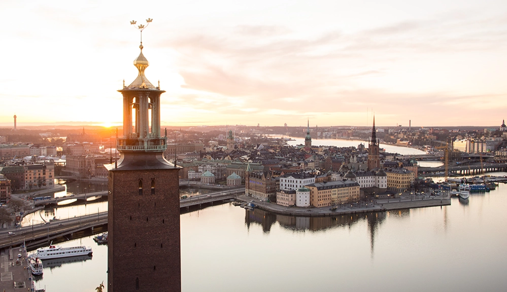 Stockholm City Hall tower above the waterfront during a long summer sunset