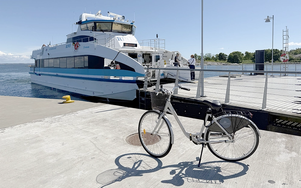 A bicycle parked beside a ferry at Vrångö in Gothenburg’s Southern Archipelago on a clear summer day