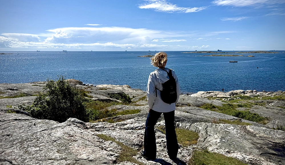 A visitor looking out over the sea and islands from the historic pilot lookout on Vrångö