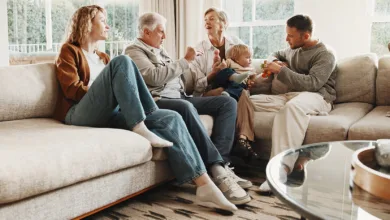 Grandparents, adult children and a baby together in a living room