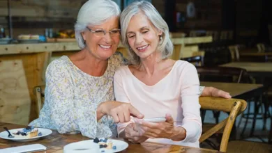 Two old friends catching up over coffee in a cafe, laughing and sharing stories