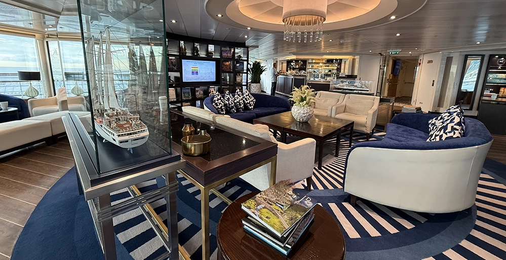 Think You Don't Like Cruises? You Might Just Be on the Wrong Ship 3 The Yacht Club lounge aboard Star Legend with sofas, books and floor-to-ceiling windows